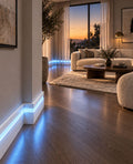 Modern polymer LED skirting board with front cover channel installed along a contemporary interior wall